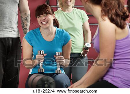 Woman lifting weights in gym View Large Photo Image Picture - Woman lifting weights in gym. Fotosearch