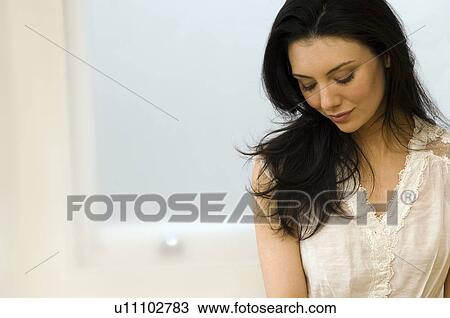 Stock Image - Woman looking down. Fotosearch