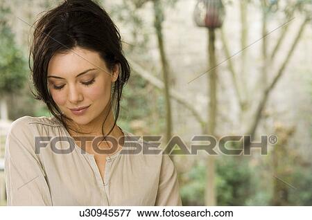 Woman looking down View Large Photo Image Stock Photo - Woman looking down. Fotosearch