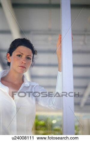 Woman looking through window View Large Photo Image Stock Image - Woman looking through window. Fotosearch