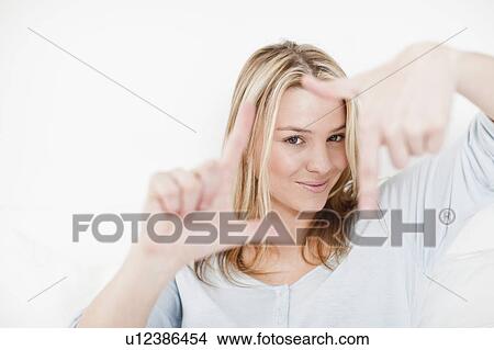 Picture - Woman making square with her fingers. Fotosearch