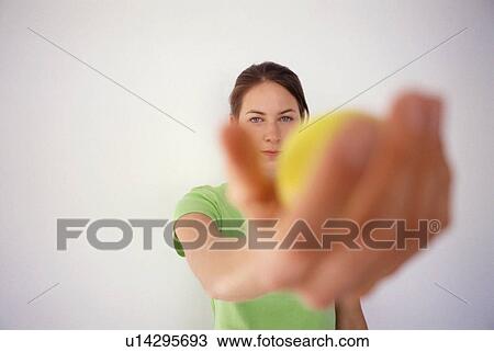 Woman offering tennis ball View Large Photo Image Stock Image - Woman offering tennis ball. Fotosearch
