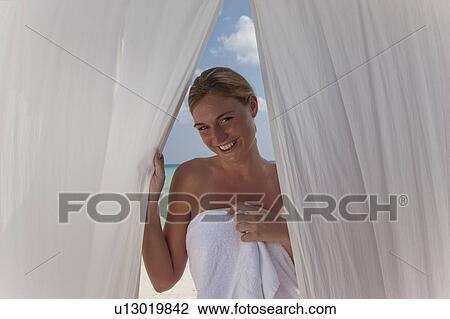 Woman on beach behind white curtains View Large Photo Image Stock Image - Woman on beach behind white curtains. Fotosearch