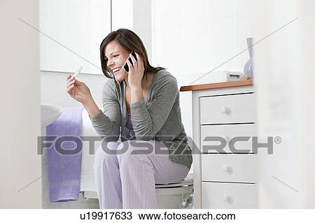 Woman on cell phone with pregnancy test View Large Photo Image Stock Image - Woman on cell phone with pregnancy test. Fotosearch