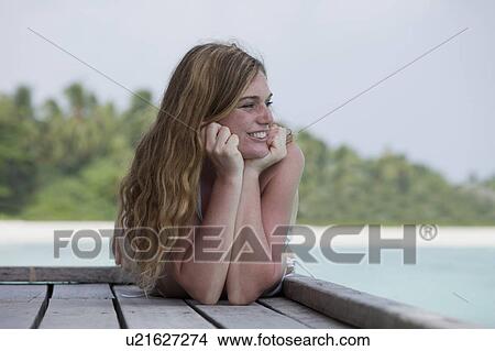 Woman on deck overlooking beach View Large Photo Image Picture - Woman on deck overlooking beach. Fotosearch