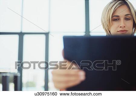 Stock Image - Woman opening laptop. Fotosearch