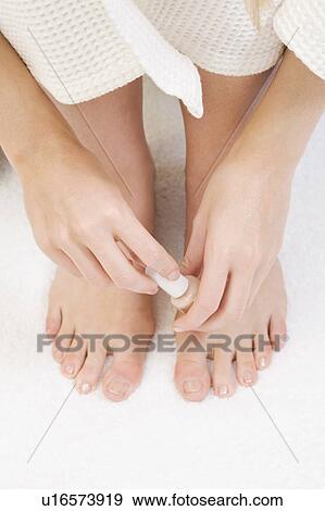 Stock Photo - Woman painting her toenails. Fotosearch