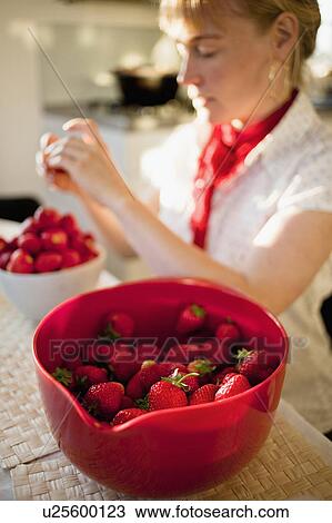 Woman paring strawberries in kitchen View Large Photo Image Stock Image - Woman paring strawberries in kitchen. Fotosearch