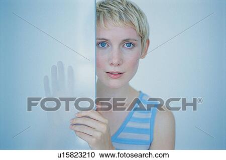 Woman peeking around doorway View Large Photo Image Stock Image - Woman peeking around doorway. Fotosearch