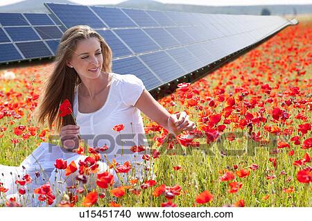 Woman picking flowers by solar panels View Large Photo Image Stock Image - Woman picking flowers by solar panels. Fotosearch