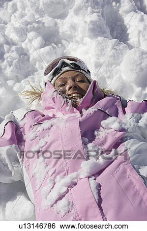 Stock Photograph - Woman playing in snow. Fotosearch