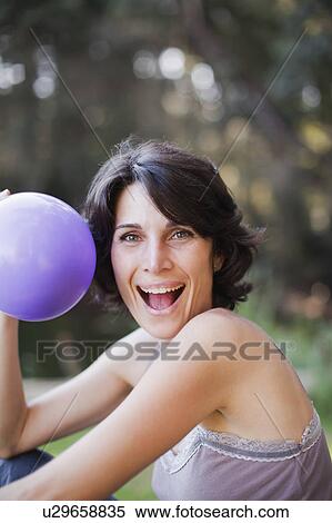 Woman playing with balloon outdoors View Large Photo Image Stock Photography - Woman playing with balloon outdoors. Fotosearch