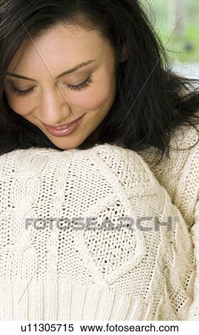 Woman pulling sweater over her knees View Large Photo Image Stock Photography - Woman pulling sweater over her knees. Fotosearch