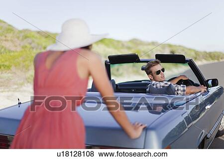 Woman pushing car as boyfriend steers View Large Photo Image Stock Photo - Woman pushing car as boyfriend steers. Fotosearch