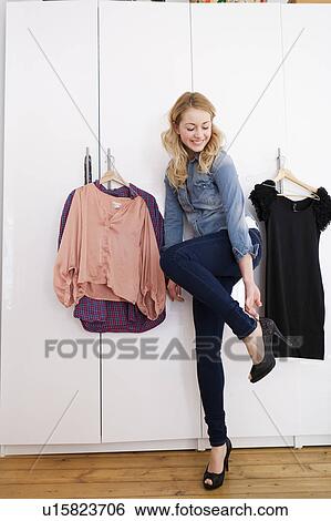 Stock Photograph - Woman putting on high heels . Fotosearch
