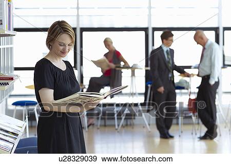 Woman reading book in library View Large Photo Image Stock Photo - Woman reading book in library. Fotosearch