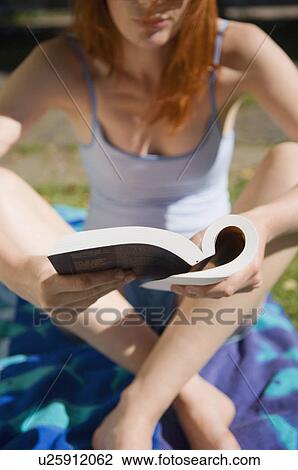 Woman reading book outdoors View Large Photo Image Stock Image - Woman reading book outdoors. Fotosearch