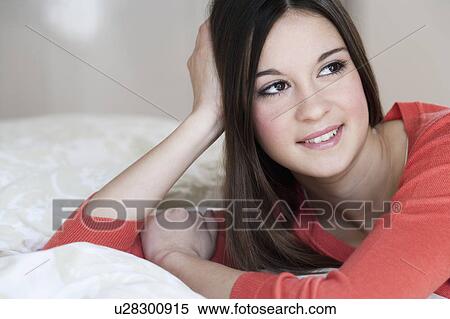 Stock Photography - Woman relaxing on bed. Fotosearch