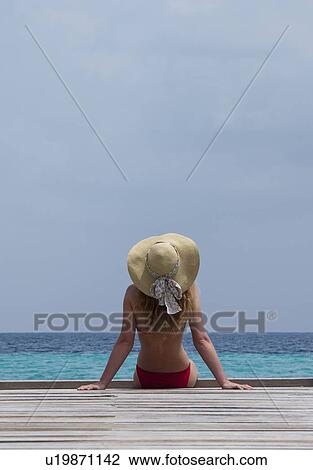 Woman relaxing on deck overlooking sea View Large Photo Image Stock Image - Woman relaxing on deck overlooking sea. Fotosearch