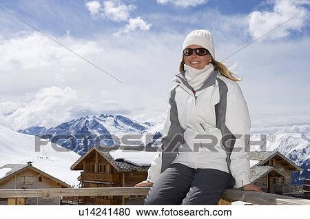 Woman relaxing on ski lodge balcony View Large Photo Image Stock Image - Woman relaxing on ski lodge balcony. Fotosearch