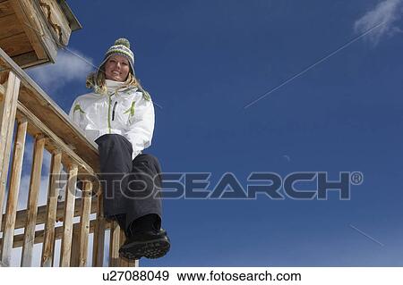 Woman relaxing on ski lodge balcony View Large Photo Image Stock Photo - Woman relaxing on ski lodge balcony. Fotosearch