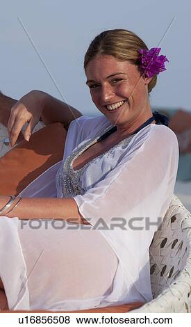 Woman relaxing on tropical beach View Large Photo Image Stock Photo - Woman relaxing on tropical beach. Fotosearch