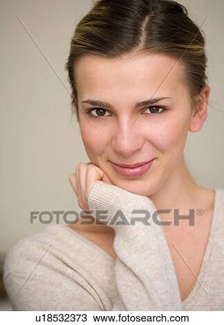Stock Image - Woman resting chin in hand. Fotosearch