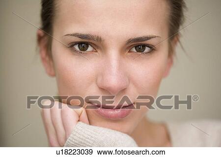 Woman resting chin in hand View Large Photo Image Stock Photo - Woman resting chin in hand. Fotosearch
