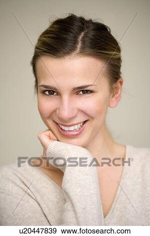 Woman resting chin in hand View Large Photo Image Stock Photo - Woman resting chin in hand. Fotosearch