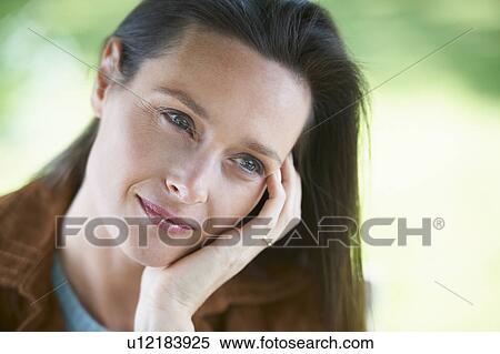 Woman resting chin in hand View Large Photo Image Stock Photography - Woman resting chin in hand. Fotosearch