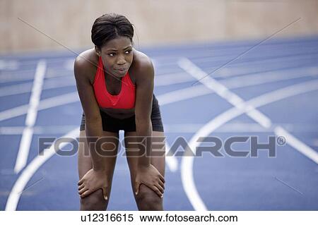 Woman resting on running track View Large Photo Image Stock Photography - Woman resting on running track. Fotosearch