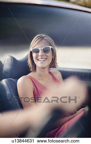 Stock Image - Woman riding in convertible. Fotosearch