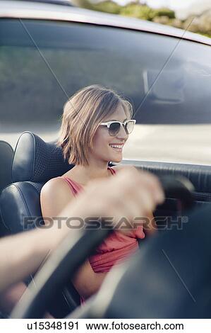 Woman riding in convertible View Large Photo Image Stock Image - Woman riding in convertible. Fotosearch