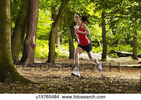 Woman running in forest View Large Photo Image Picture - Woman running in forest. Fotosearch