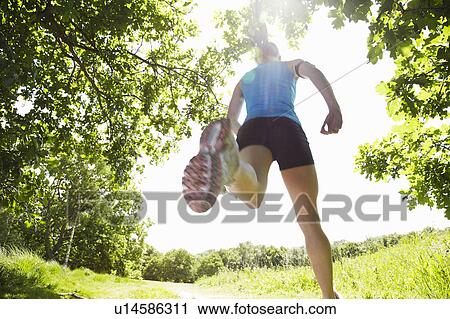 Woman running in forest View Large Photo Image Stock Image - Woman running in forest. Fotosearch