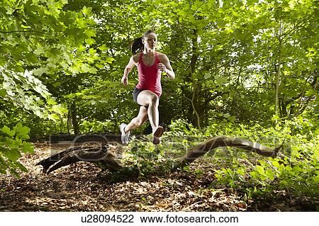 Woman running in forest View Large Photo Image Stock Image - Woman running in forest. Fotosearch