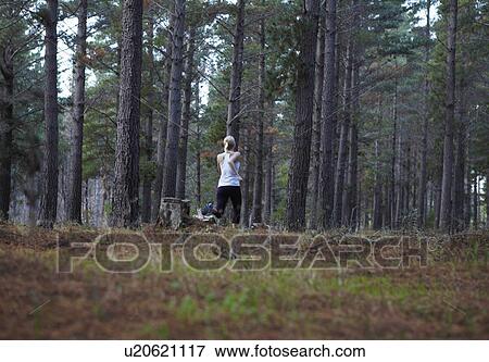 Woman running in forest View Large Photo Image Stock Photo - Woman running in forest. Fotosearch