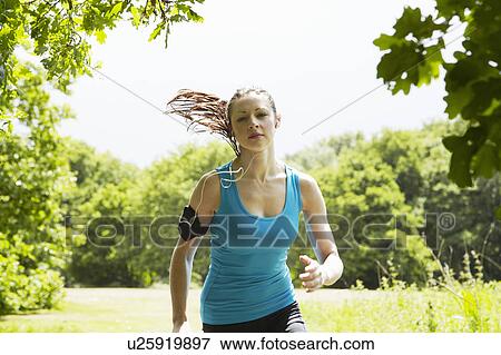 Woman running in forest View Large Photo Image Stock Photo - Woman running in forest. Fotosearch