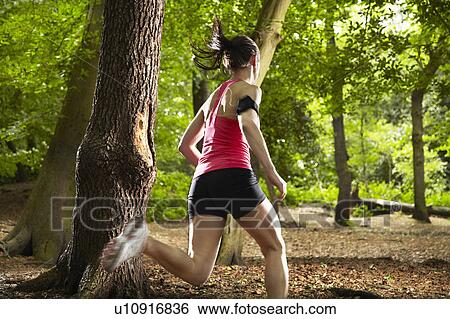 Stock Photograph - Woman running in forest. Fotosearch