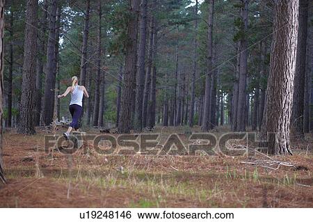 Woman running in forest View Large Photo Image Stock Photograph - Woman running in forest. Fotosearch