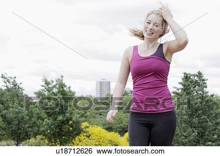 Stock Photograph - Woman running in park. Fotosearch