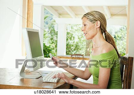 Woman shopping on the internet View Large Photo Image Stock Image - Woman shopping on the internet. Fotosearch