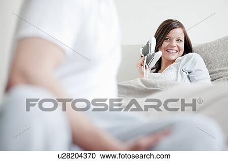 Woman showing baby shoes to boyfriend View Large Photo Image Stock Image - Woman showing baby shoes to boyfriend. Fotosearch