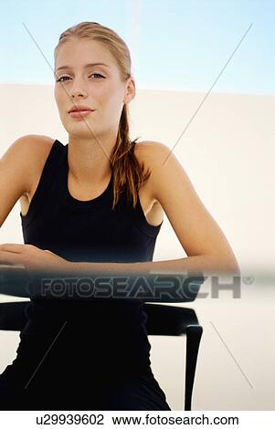 Woman sitting at glass desk View Large Photo Image Stock Image - Woman sitting at glass desk. Fotosearch