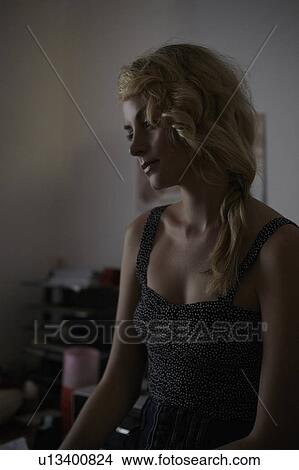 Picture - Woman sitting in bedroom. Fotosearch