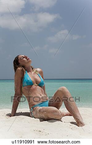 Woman sitting in sand on tropical beach View Large Photo Image Stock Image - Woman sitting in sand on tropical beach. Fotosearch