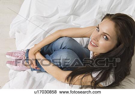 Woman sitting on couch in new home View Large Photo Image Stock Photo - Woman sitting on couch in new home. Fotosearch