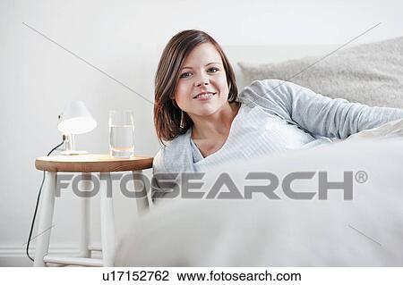 Woman sitting up in bed View Large Photo Image Stock Image - Woman sitting up in bed. Fotosearch