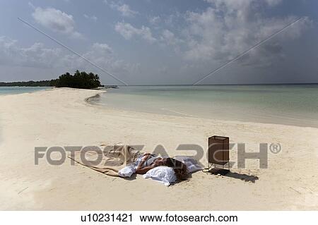 Woman sleeping in bed on beach View Large Photo Image Stock Image - Woman sleeping in bed on beach. Fotosearch