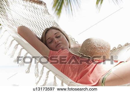 Woman sleeping in hammock on beach View Large Photo Image Stock Photo - Woman sleeping in hammock on beach. Fotosearch